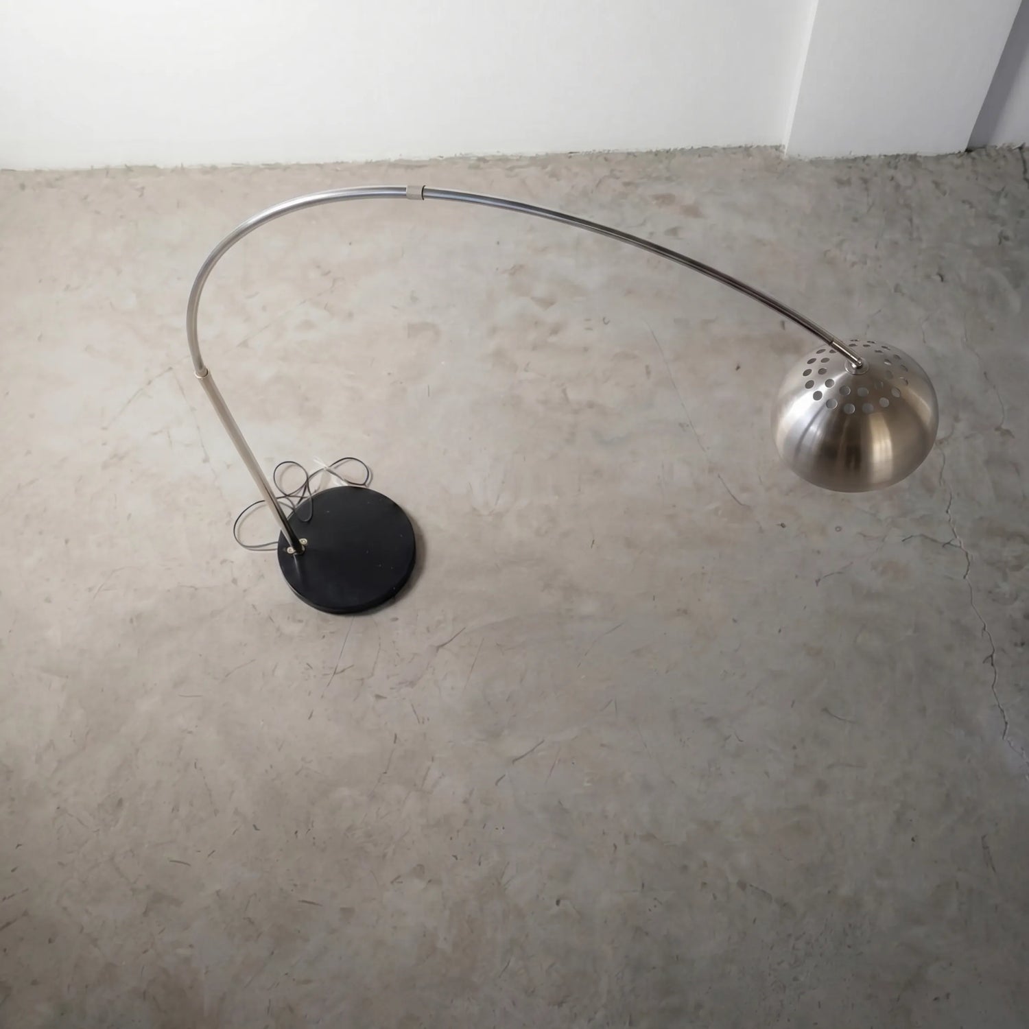 Aura Arc Floor Lamp, a modern arc floor lamp with a curved silhouette for living rooms, angled view