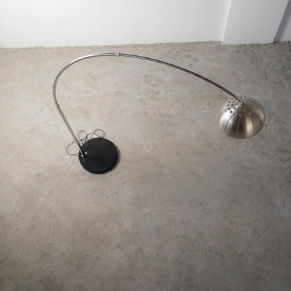 Aura Arc Floor Lamp, a modern arc floor lamp with a curved silhouette for living rooms, angled view
