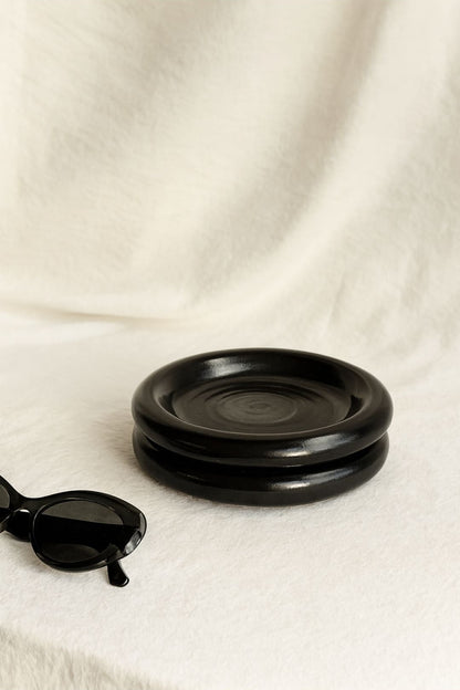 Cozy breakfast setup with Gustaf Westman–inspired black chunky ceramic plate on the white table with sunglasses