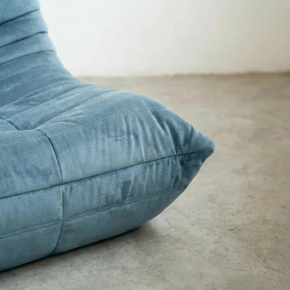 Close up of the bottom corner of the Bruma 3 seater sofa in light blue Velvet Suede