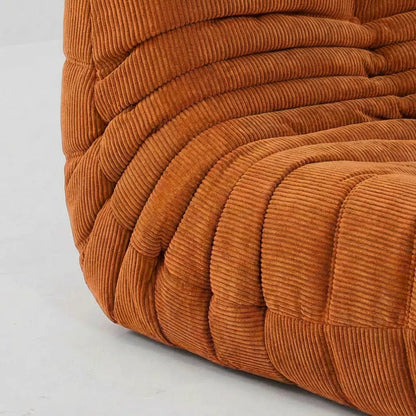 Close-up of the orange corduroy suede upholstery Bruma fireside chair lounger – soft, dirt-resistant fabric with luxurious texture