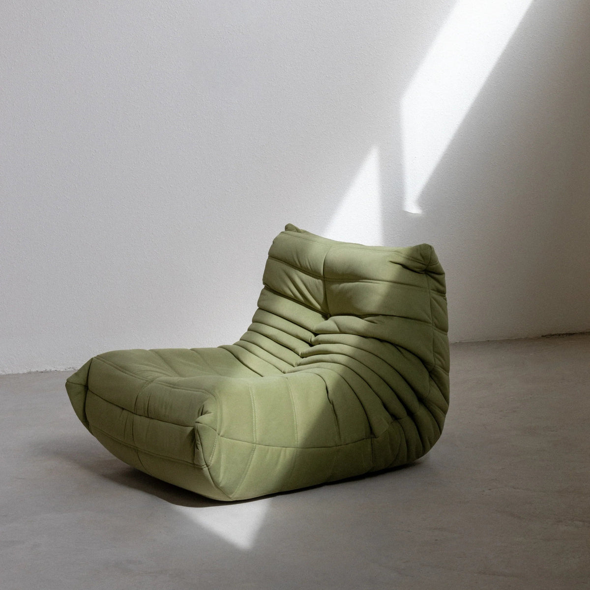 Bruma Chair in green velvet photographed from the side by vibehaus