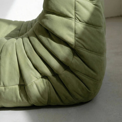 Close up of the Bruma chair in green velvet suede by vibehaus, sideangle