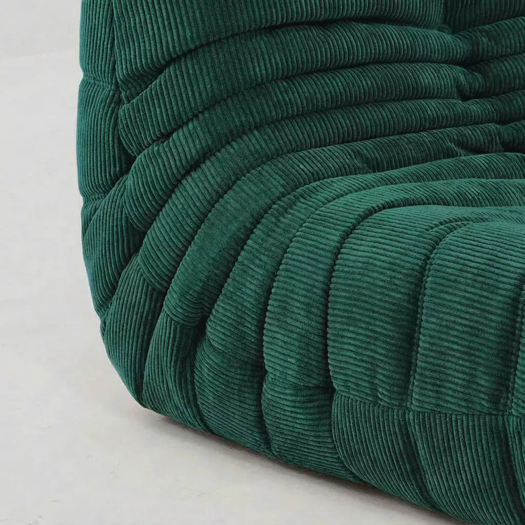 Close up sofa chair in corduroy green – plush high-density sponge filling for ergonomic comfort