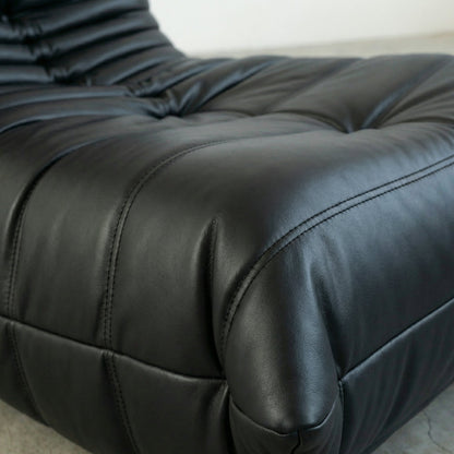 Close up of the Bruma Chair in black faux leather by vibehaus