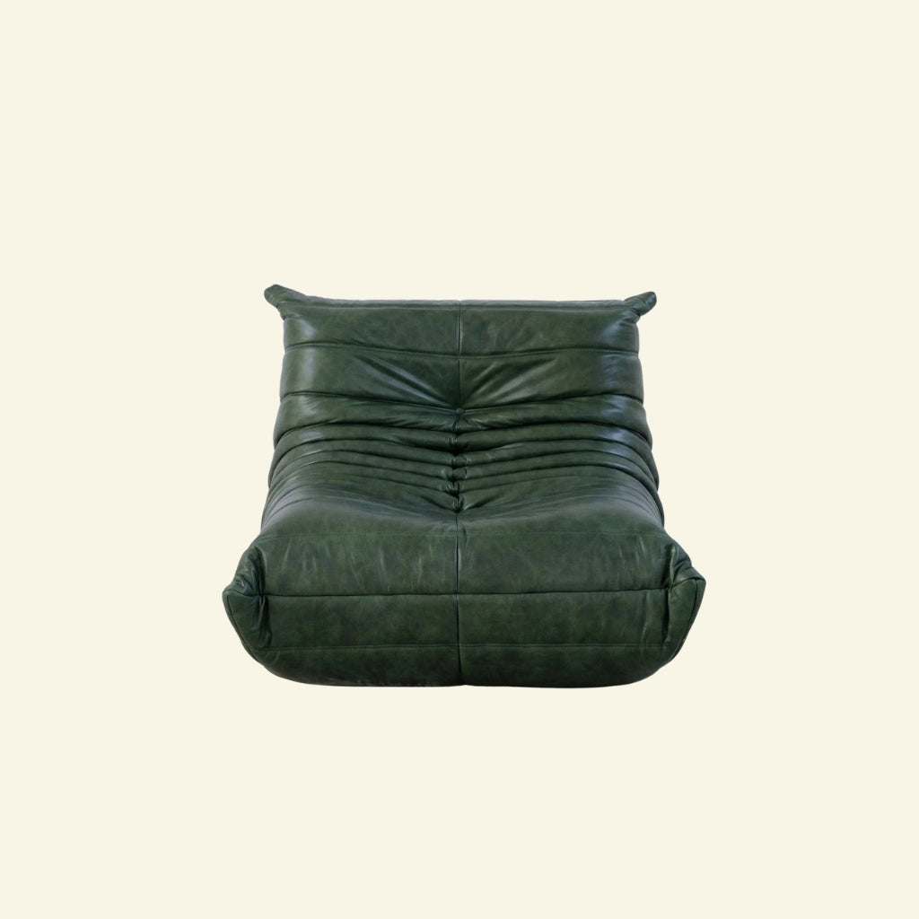 Bruma Chair in green real oil wax leather on a beige background by vibehaus