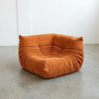Bruma Sofa Corner in orange corduroy photographed from the front angle.