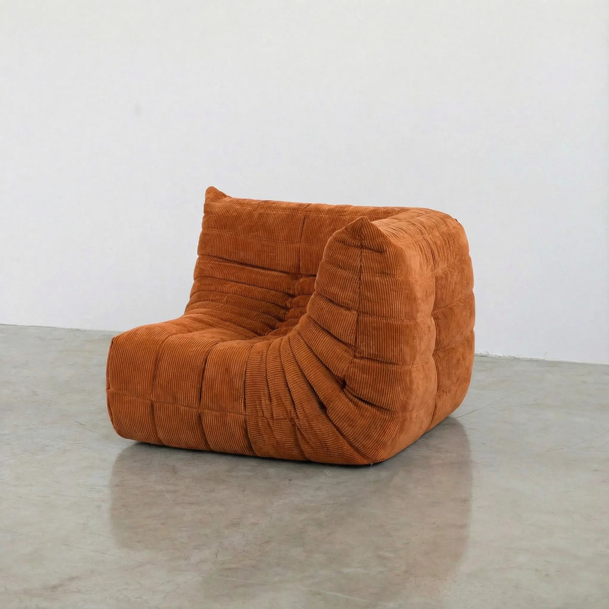 Bruma Sofa Corner in orange corduroy photographed from the side angle.