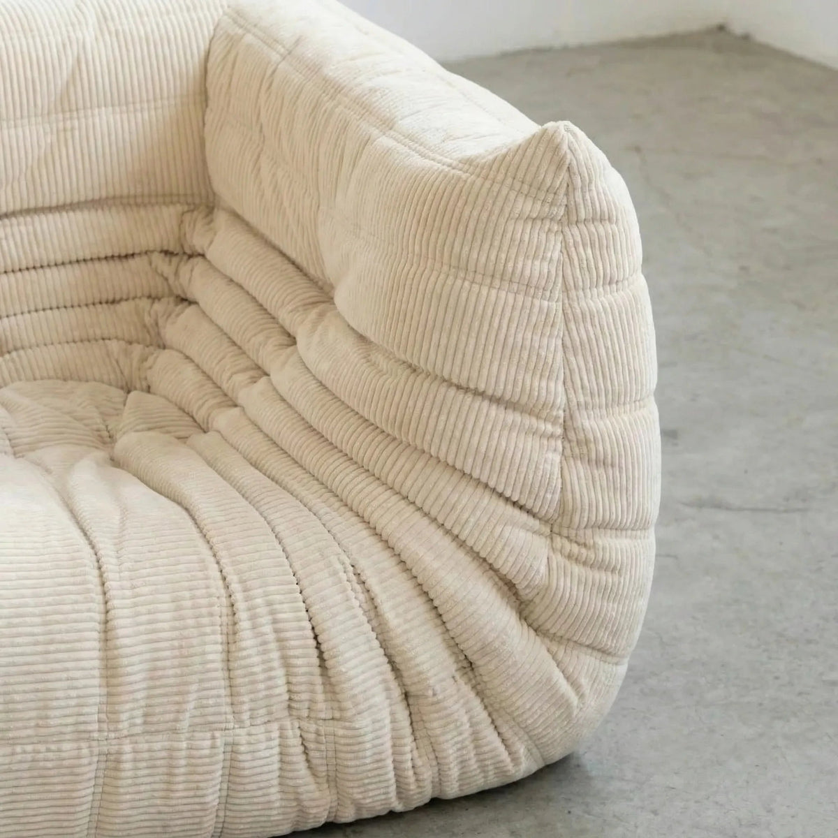 Close up of the Bruma Sofa Corner in cream corduroy photographed from the side angle.