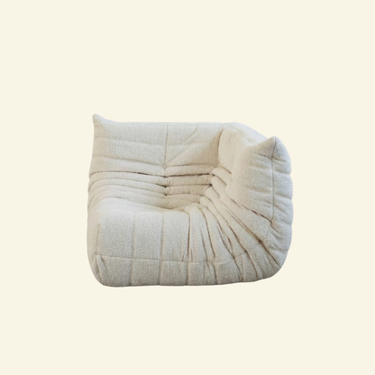 Bruma Sofa Corner in white bouclé on a beige background