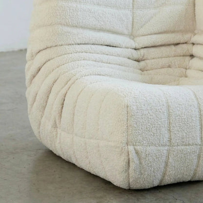 Close up of the Bruma Sofa Corner in white bouclé photographed from the front angle.