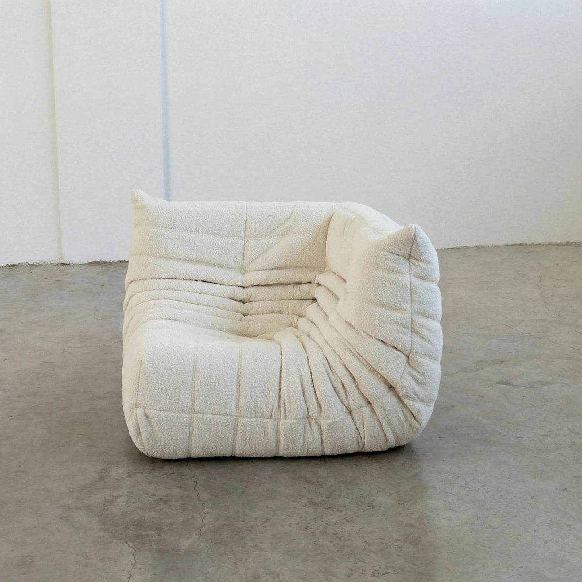 Bruma Sofa Corner in white bouclé photographed from the front angle.