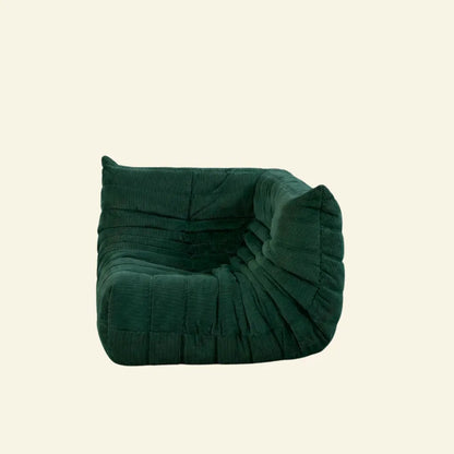 Bruma Sofa Corner in dark green corduroy on a beige background