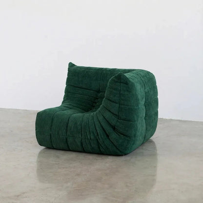 Bruma Sofa Corner in dark green corduroy photographed from the front angle.
