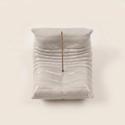 Top view of the grey Bruma incense holder highlighting its pleated seat shape and incense holder placement.