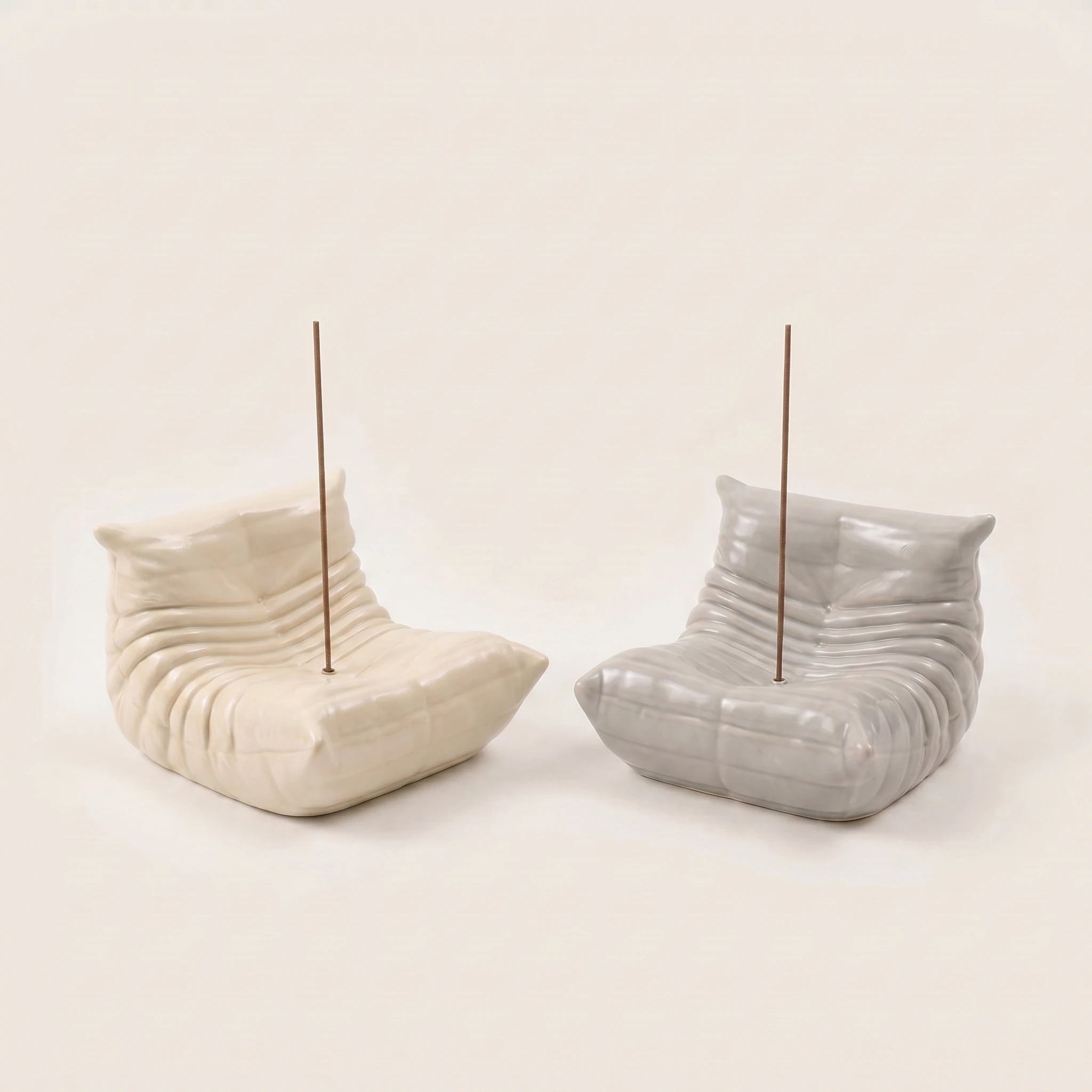 Cream and grey Bruma incense holder shown together to display both color variants.