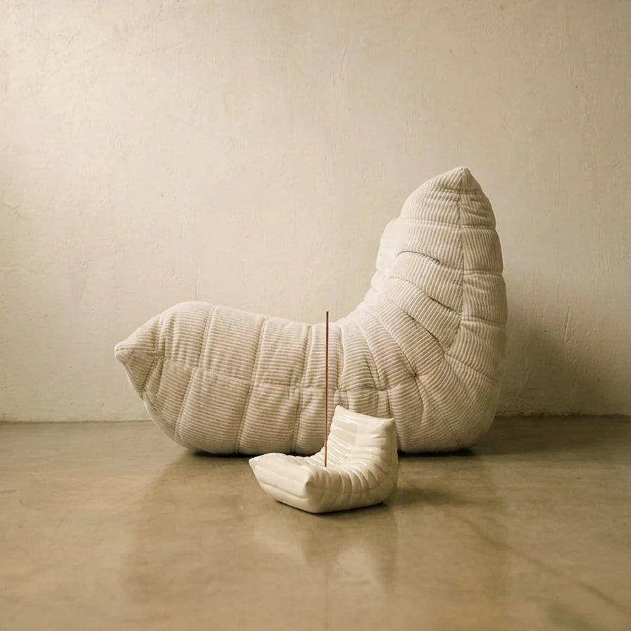 Cream Bruma incense holder styled in front of a full-size pleated lounge chair for a Togo-inspired decor moment.