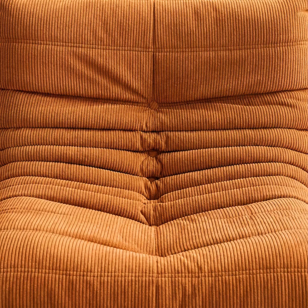Close-up of a orange corduroy fabric texture of the Bruma sofa by vibehaus