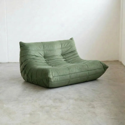 Matcha-green velvet Bruma 2-seater sofa – low, frameless design with plush channel tufting