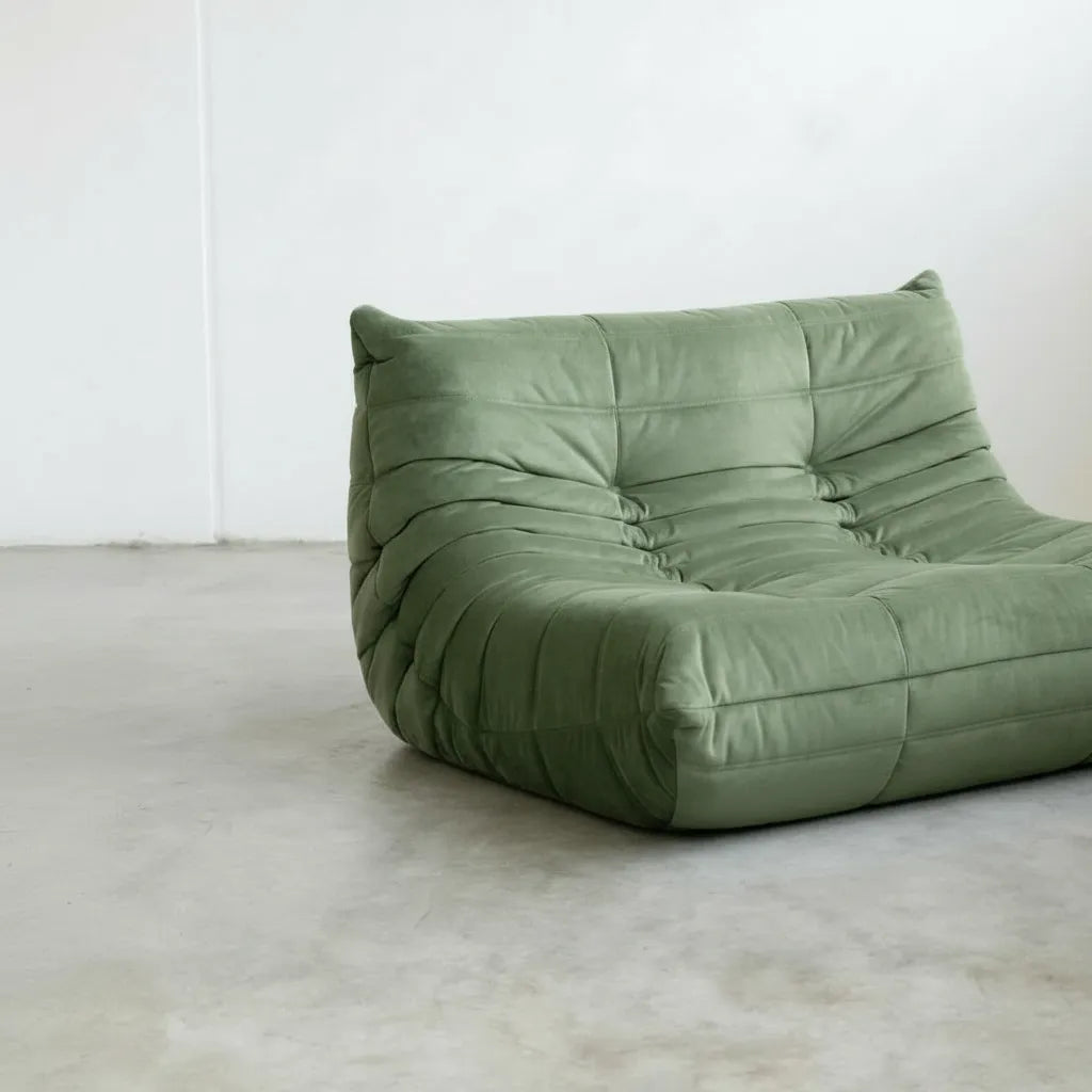 Close-up of green velvet suede upholstery Bruma lounger schair – soft, dirt-resistant fabric with luxurious texture
