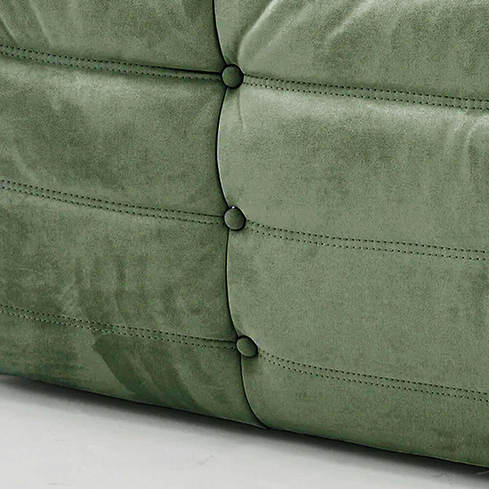 Close-up of green velvet suede upholstery Bruma lounger schair – soft, dirt-resistant fabric with luxurious texture