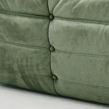 Close-up of green velvet suede upholstery Bruma lounger schair – soft, dirt-resistant fabric with luxurious texture