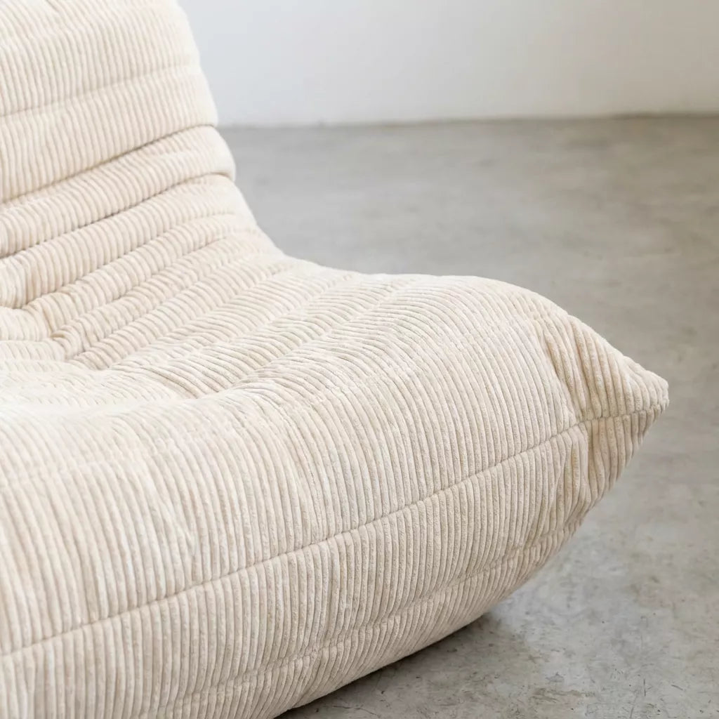 Close up of the corner of the Bruma 2-seater Sofa in cream corduroy with Bruma silhouette – custom-made by vibehaus