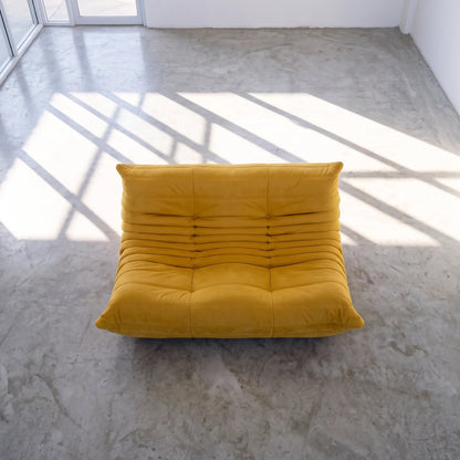 Bruma sofa in yellow velvet viewed from above in a bright studio by vibehaus