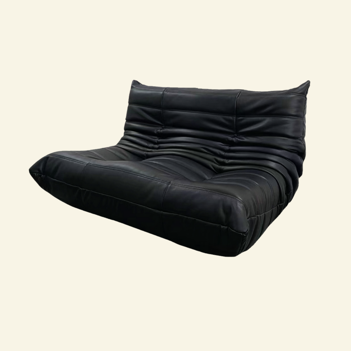 Black leather lounge loveseat on a beige background