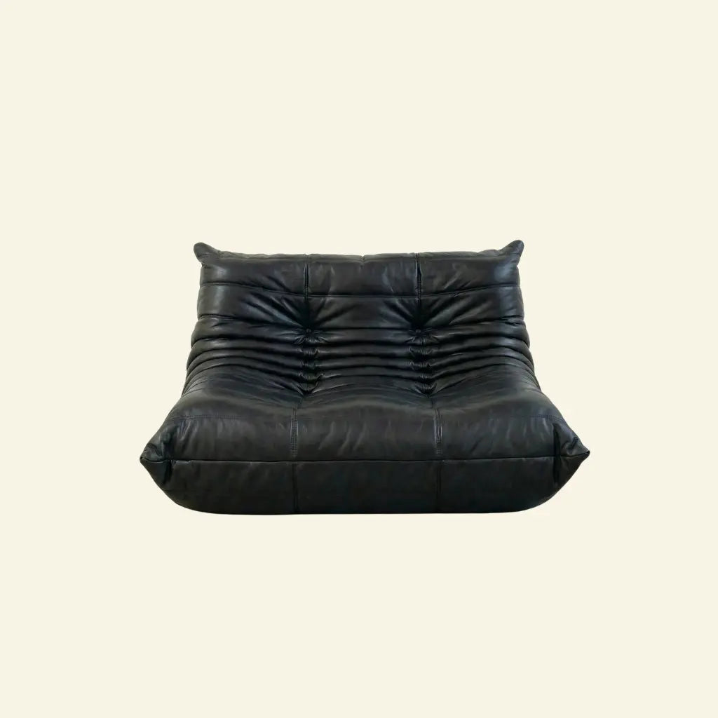 Black Bruma sofa in leather on a light beige background