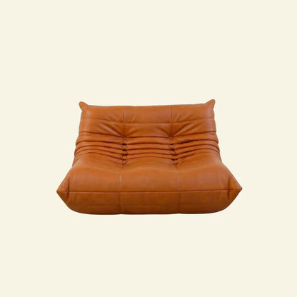 Orange Cognac Bruma sofa in leather on a light beige background