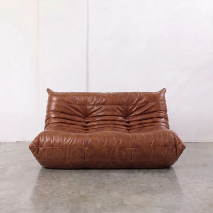 Brown Bruma sofa in leather in a studio setting