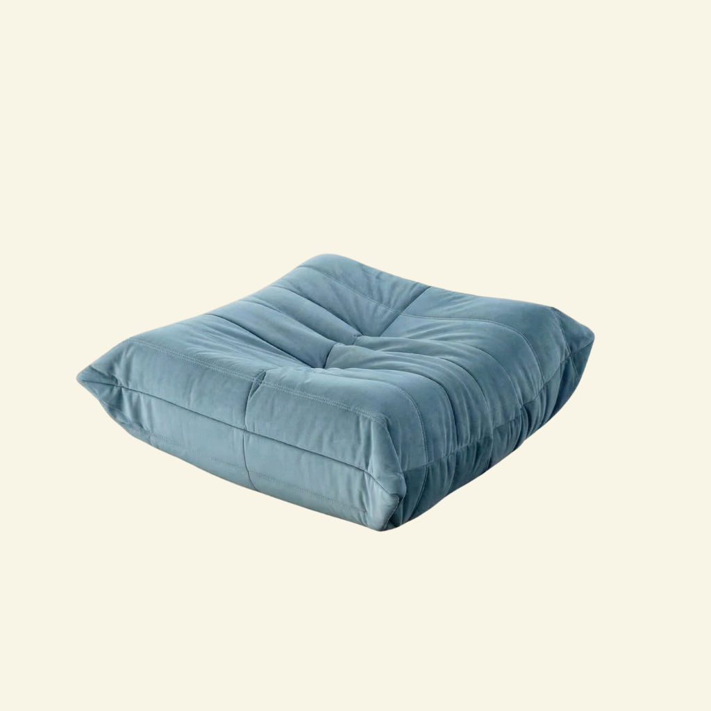 Bruma Ottoman in blue velvet on beige background
