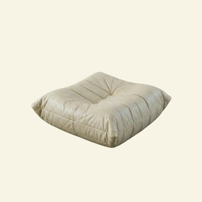 Beige Bruma leather ottoman on a beige background