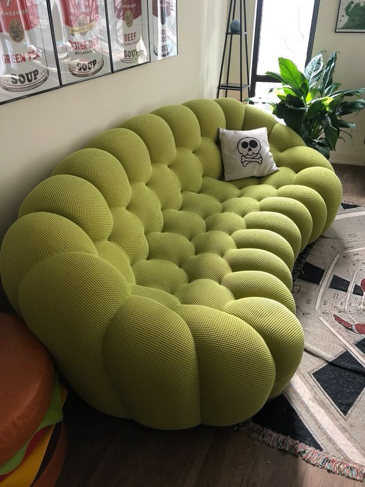 Green textured bubble sofa dupe with a skull-patterned pillow in a living room setting.