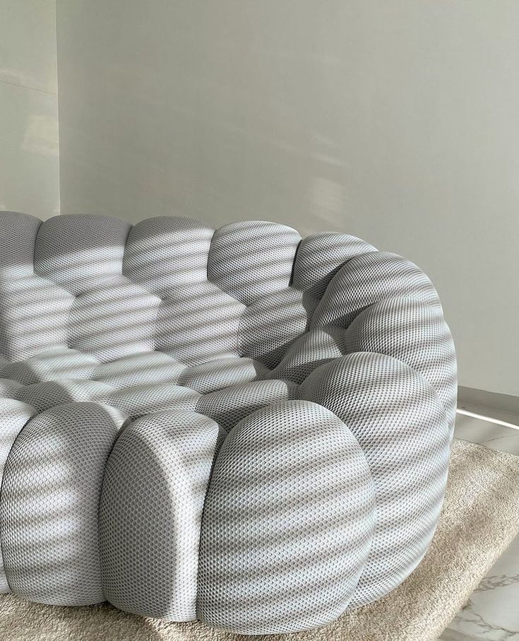Modern, textured bubble sofa replica  in a minimalistic room with light-colored floor and wall.