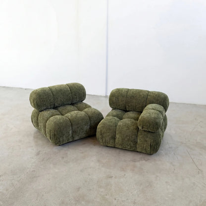 Pair of Green camaleonda inspired armchairs in chenille on a white floor with a white wall background