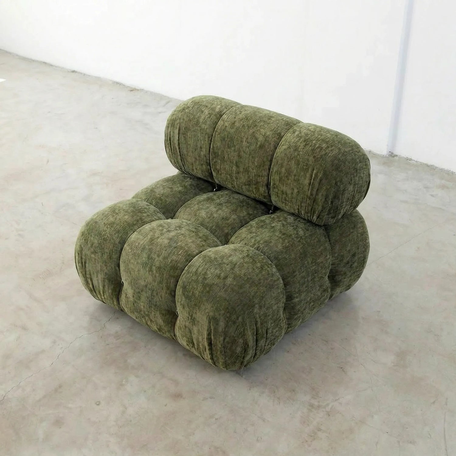 Green camaleonda armchair dupe in chenille on a white floor with a white wall background