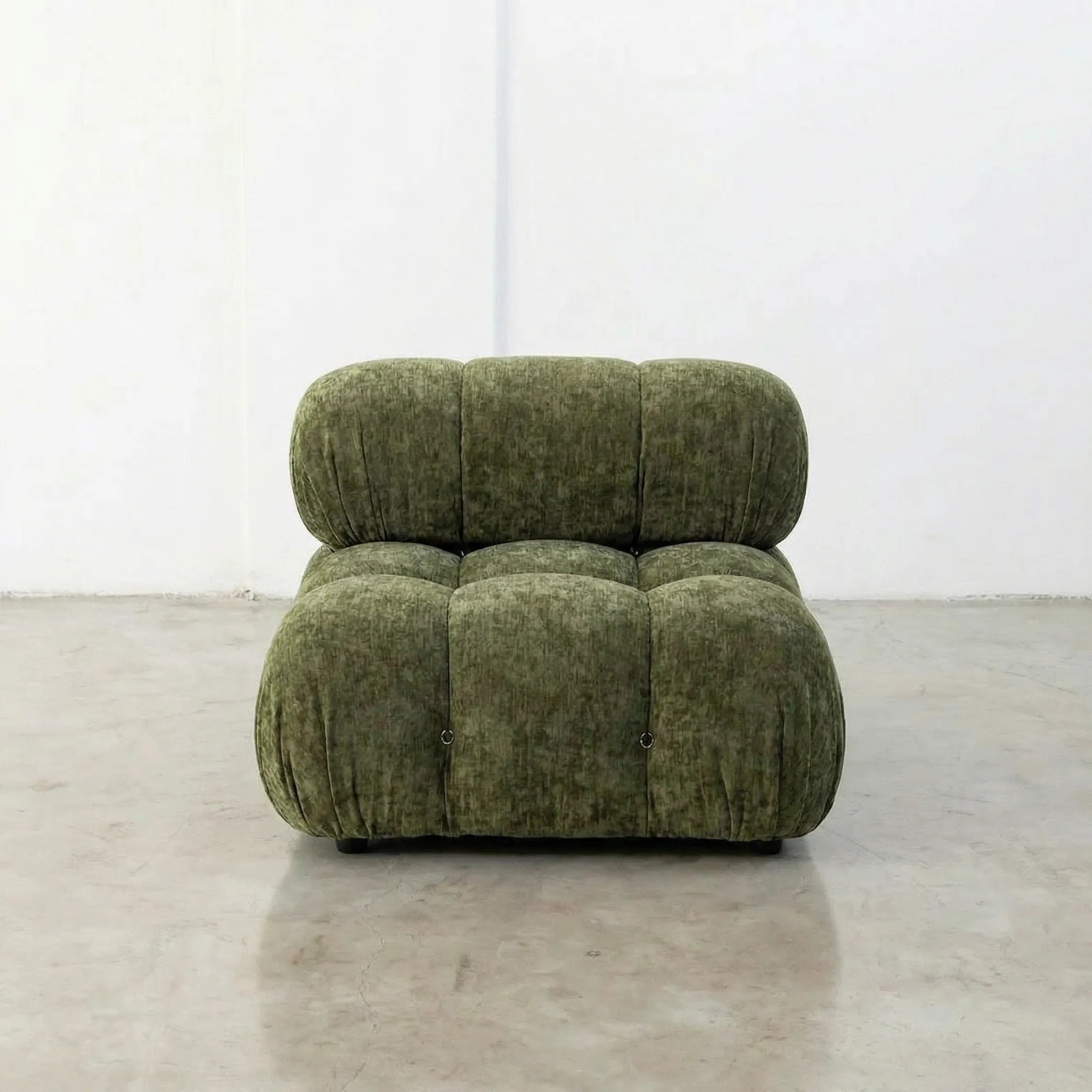Green camaleonda alternative armchair in chenille on a white floor with a white wall background