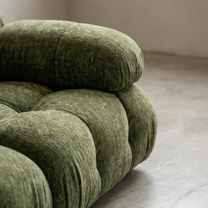 close up of the green camaleonda dupe in chenille on a white floor with a white wall background