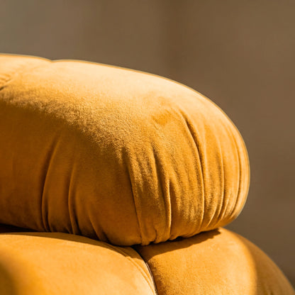 Close-up of a mustard camaleonda dupe velvet armless section in a minimalistic room with a white wall and concrete floor.