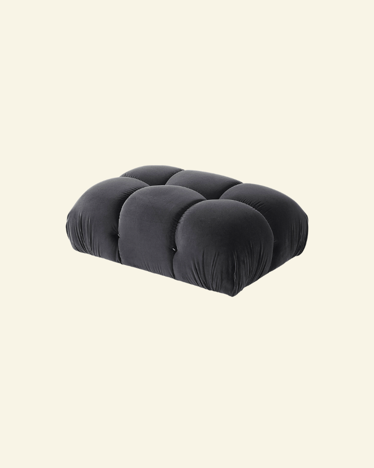 Camaleonda ottoman in black velvet replica with button-tufted detailing, shown in a high-resolution studio setting on a beige background.