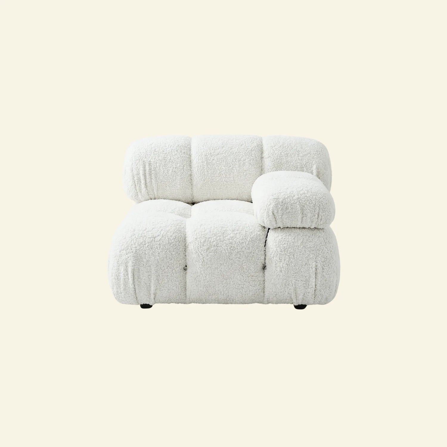 camaleonda armchair dupe with left artmrest in white boucle on a light beige background