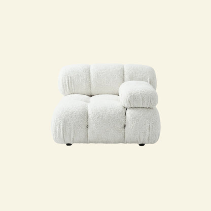 camaleonda armchair dupe with left artmrest in white boucle on a light beige background