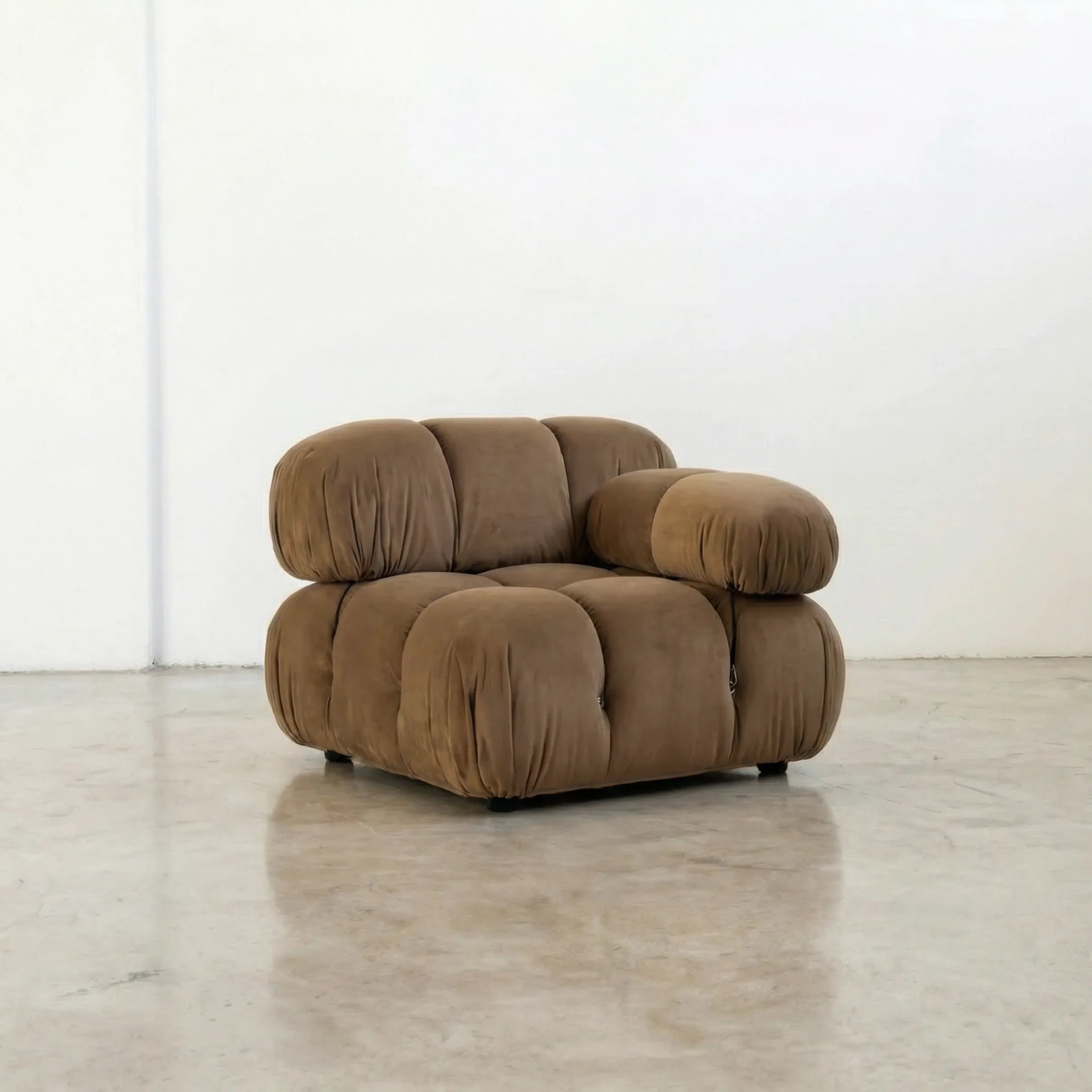 Camaleonda dupe section with armrest in brown velvet on a beige background on a white floor with a white wall background