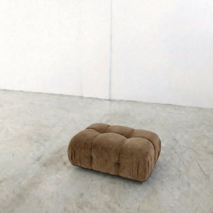 brown camaleonda ottoman alternative on a concrete floor with white walls
