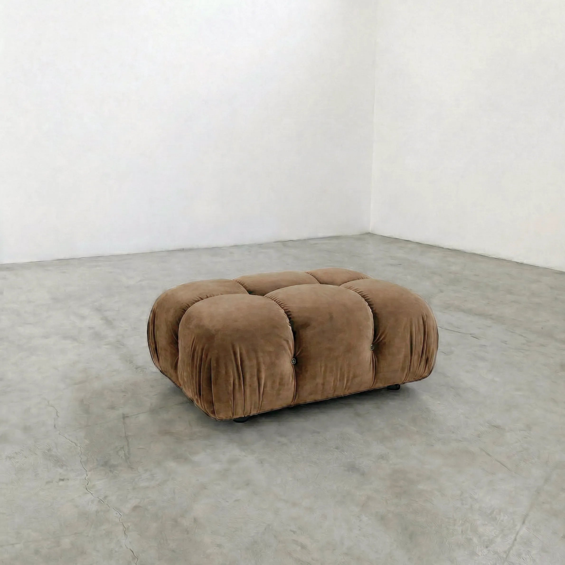 brown camaleonda ottoman alternative on a concrete floor with white walls