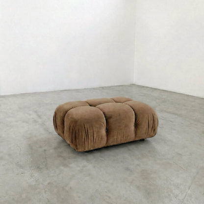brown camaleonda ottoman alternative on a concrete floor with white walls