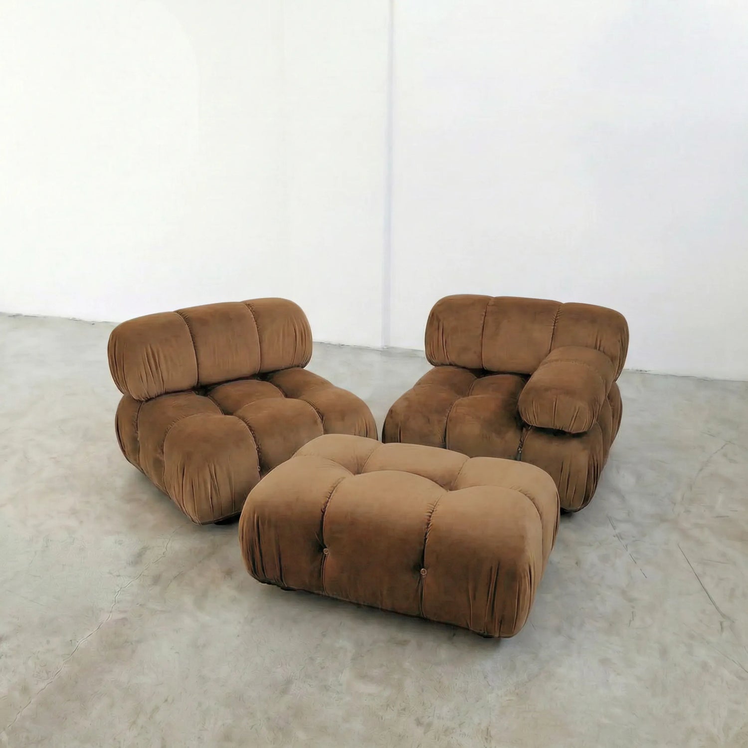 brown camaleonda ottoman and armchairs alternative on a concrete floor with white walls