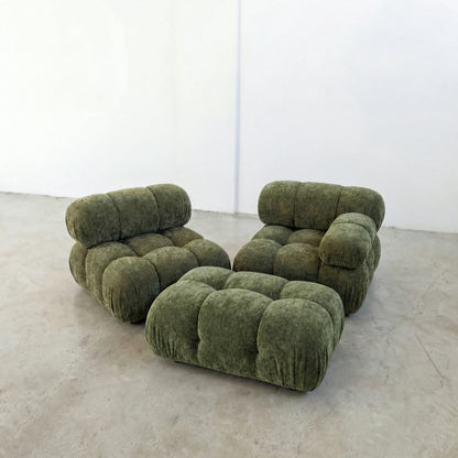 green chenille camaleonda ottoman and armchairs alternative on a concrete floor with white walls